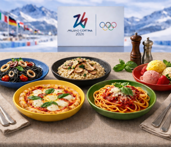Platos de comida italiana —pizza, pasta, risotto, espaguetis negros y helado— servidos en platos de colores inspirados en los aros olímpicos (azul, negro, rojo, amarillo y verde), con el logo de Milano Cortina 2026 y un paisaje de montaña al fondo.
